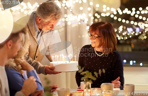 Image of happy family having birthday party at home