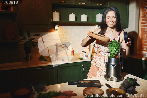 Image of Staying at home woman using mixer for to prepare vegetarian food