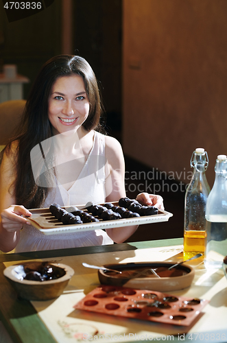 Image of Staying at home woman preparing handmade vegetarian chocolate tr