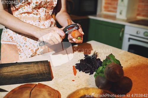 Image of Staying at home woman preparing and cooking vegetarian food