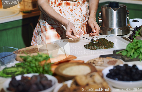 Image of Staying at home woman preparing and cooking vegetarian food