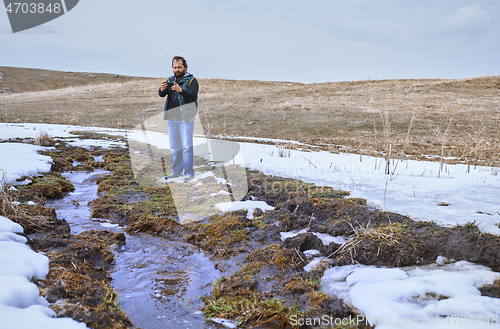 Image of Man at the swamp using geolocation on smartphone 