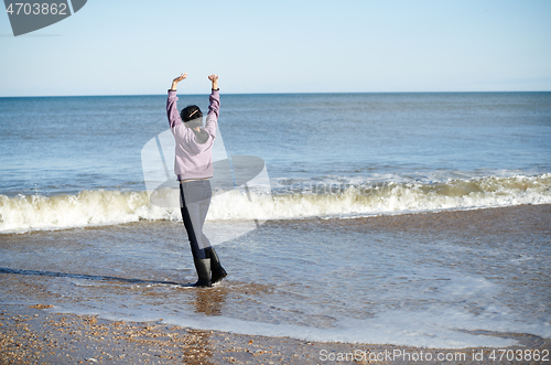 Image of Happy woman having fun at the ocean