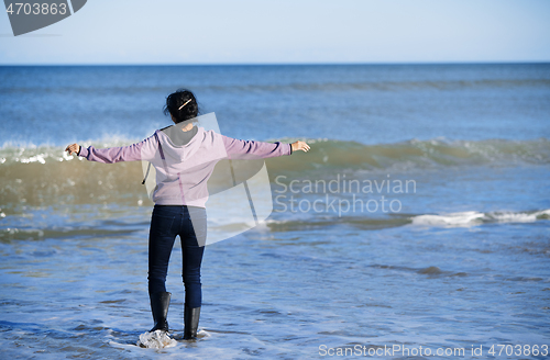 Image of Happy woman having fun at the ocean