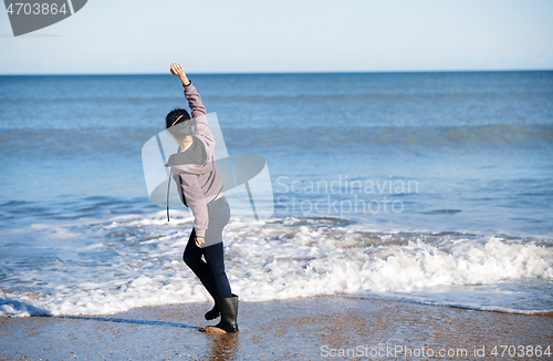 Image of Happy woman having fun at the ocean