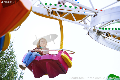 Image of Scared or boring woman riding on rollercoaster