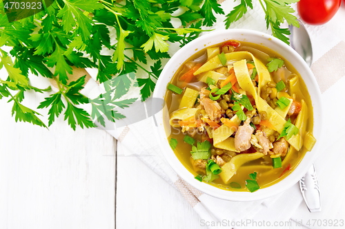 Image of Soup with mung and noodles in bowl on light board top