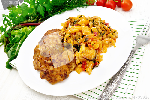 Image of Fritters meat with cabbage in plate on board