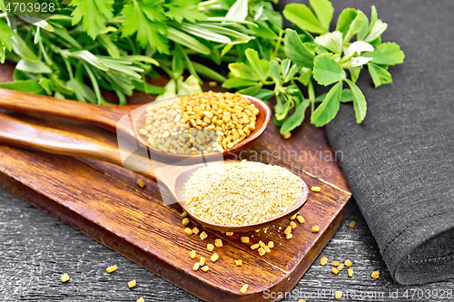 Image of Fenugreek in two spoons with herbs on black board