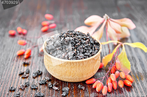 Image of Barberry dried in bowl on dark wooden board