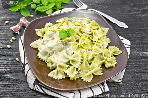 Image of Farfalle with pesto in plate on board