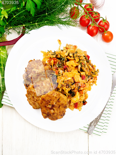 Image of Fritters meat with cabbage in plate on board top