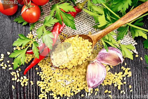 Image of Bulgur in spoon on board top