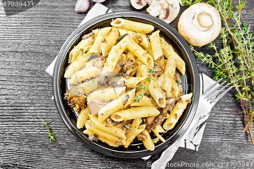 Image of Pasta with mushrooms in plate on board top