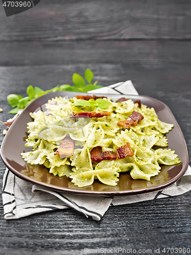 Image of Farfalle with pesto and bacon on napkin