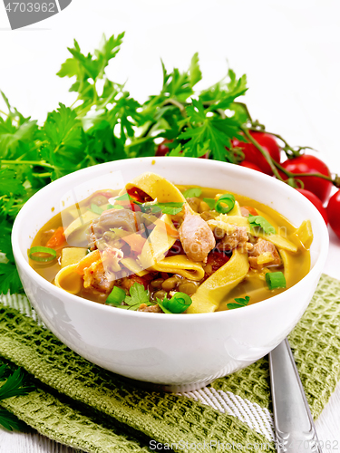 Image of Soup with mung and noodles in bowl on napkin