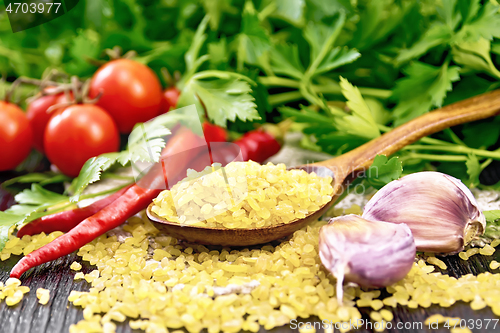 Image of Bulgur in spoon on board