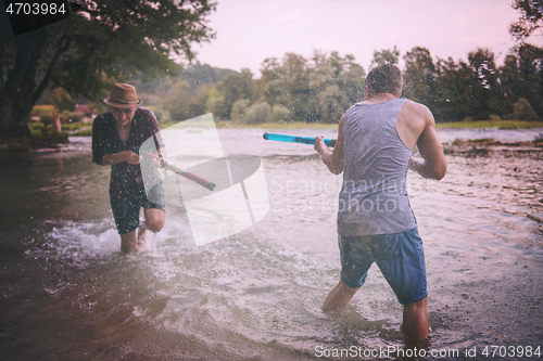 Image of young men having fun with water guns