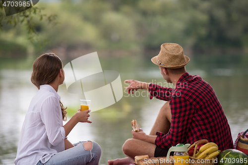 Image of Couple in love enjoying picnic time