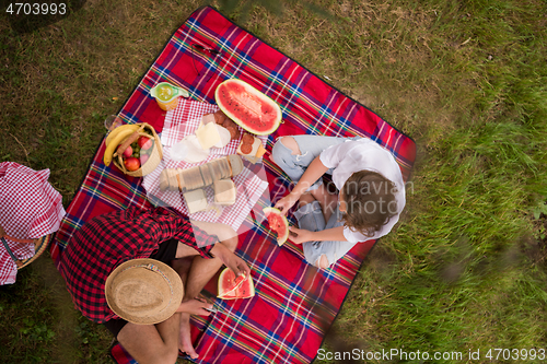 Image of top view of couple enjoying picnic time