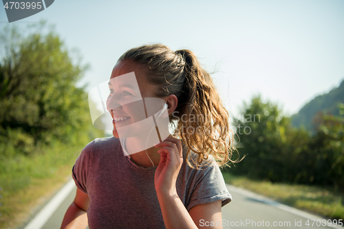 Image of woman jogging along a country road