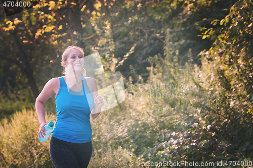 Image of woman jogging along a country road