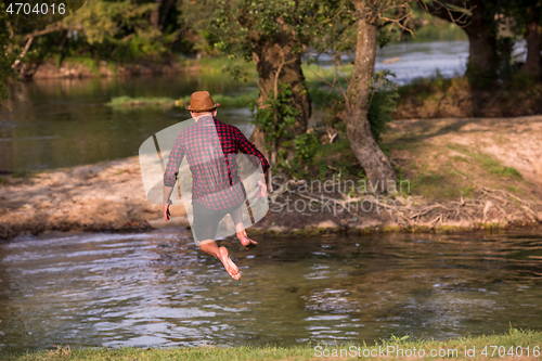 Image of man jumping into the river
