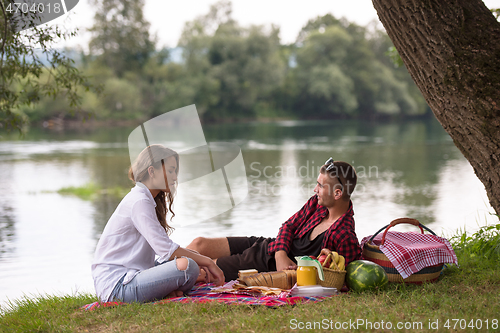 Image of Couple in love enjoying picnic time