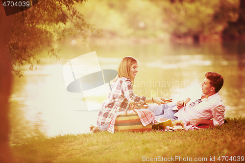 Image of Couple in love enjoying picnic time