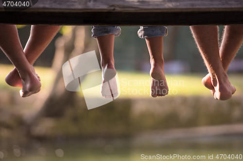 Image of people sitting at wooden bridge