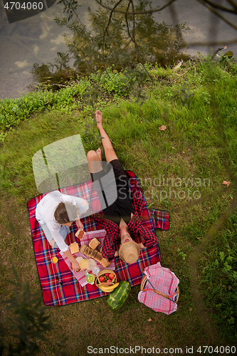 Image of top view of couple enjoying picnic time