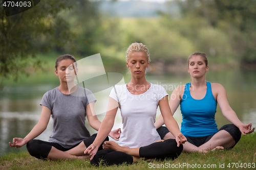 Image of women meditating and doing yoga exercise