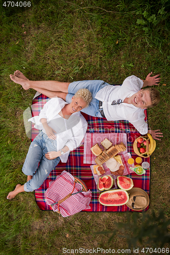 Image of top view of couple enjoying picnic time