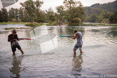 Image of young men having fun with water guns