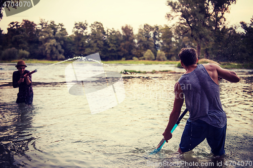 Image of young men having fun with water guns