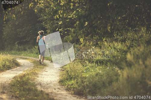 Image of woman jogging along a country road