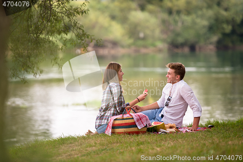 Image of Couple in love enjoying picnic time