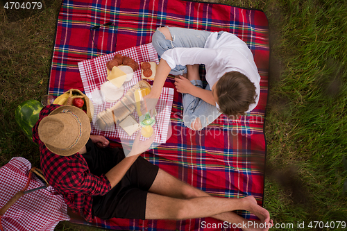 Image of top view of couple enjoying picnic time