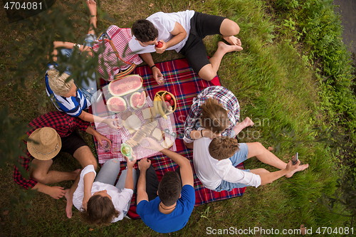 Image of top view of group friends enjoying picnic time