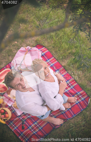 Image of top view of couple enjoying picnic time