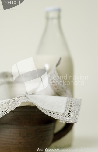 Image of bottle of milk, cup and napkin