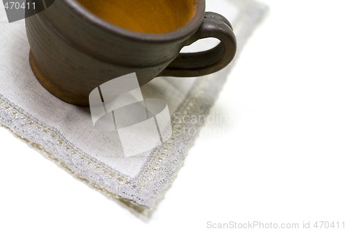 Image of empty coffee cup and linen napkin