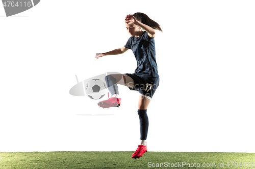 Image of Female soccer player kicking ball isolated over white background