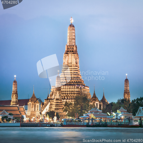 Image of Wat Arun, The Temple of Dawn, at twilight, view across Chao Phraya river. Bangkok, Thailand