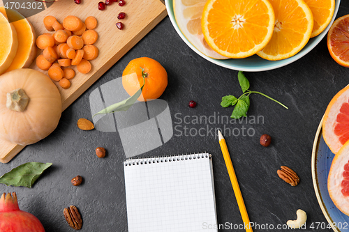 Image of close up of notebook, fruits and vegetables