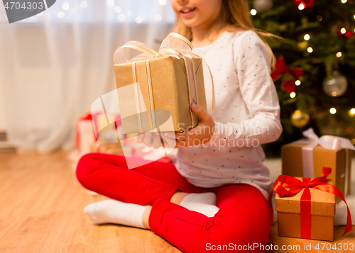 Image of close up of girl with christmas gift at home