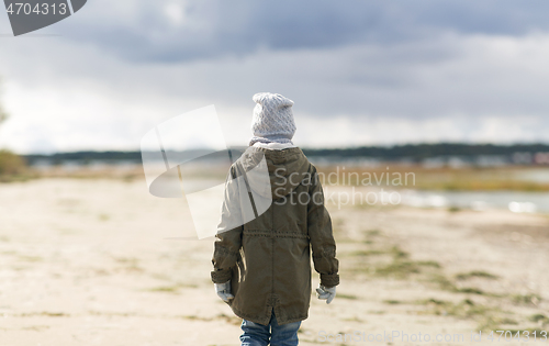 Image of little girl on beach in autumn