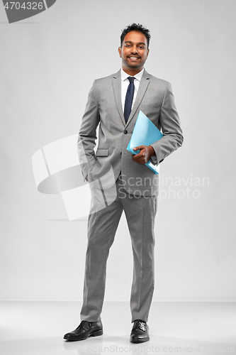 Image of indian businessman with folder over grey