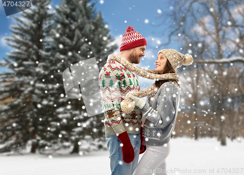 Image of couple in christmas ugly sweaters at winter park