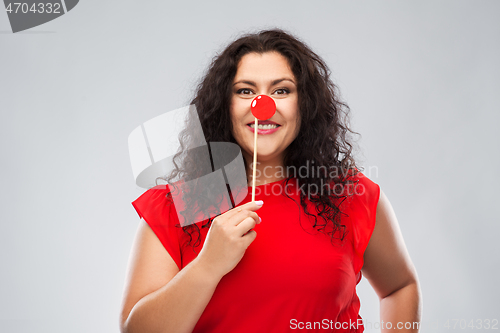 Image of happy woman with red clown nose posing